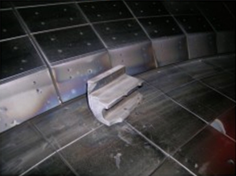 In-vessel photo of a damaged DIII-D lower divertor nose tile after a cold downward VDE